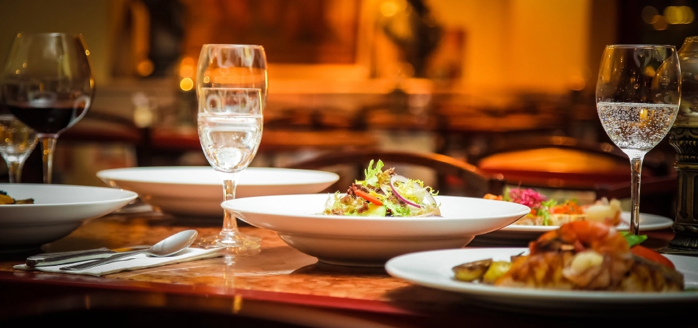 A plate of food and glasses on the table.