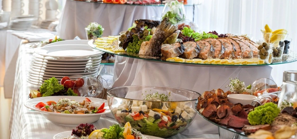 A table filled with lots of food and plates.