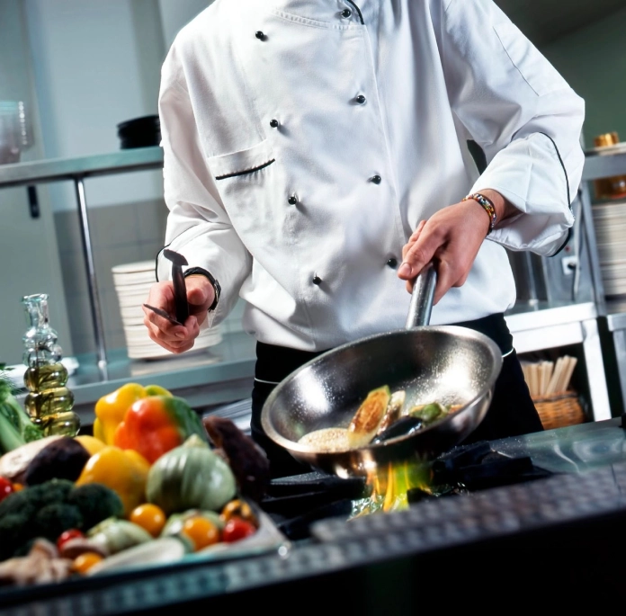 A chef is preparing food in the kitchen.