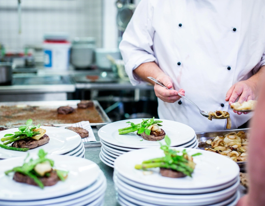 A chef is preparing food in the kitchen.