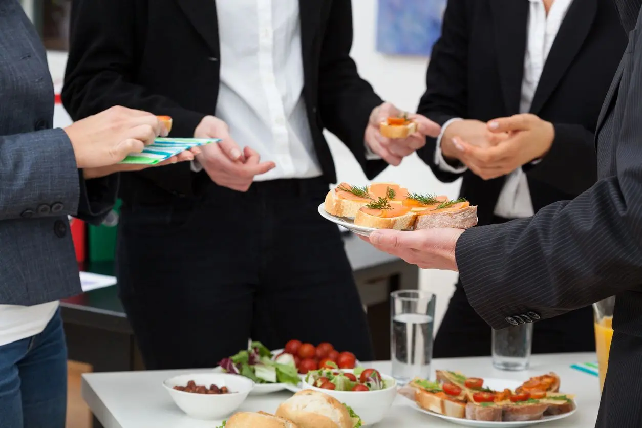 Business people eating salmon sandwiches.